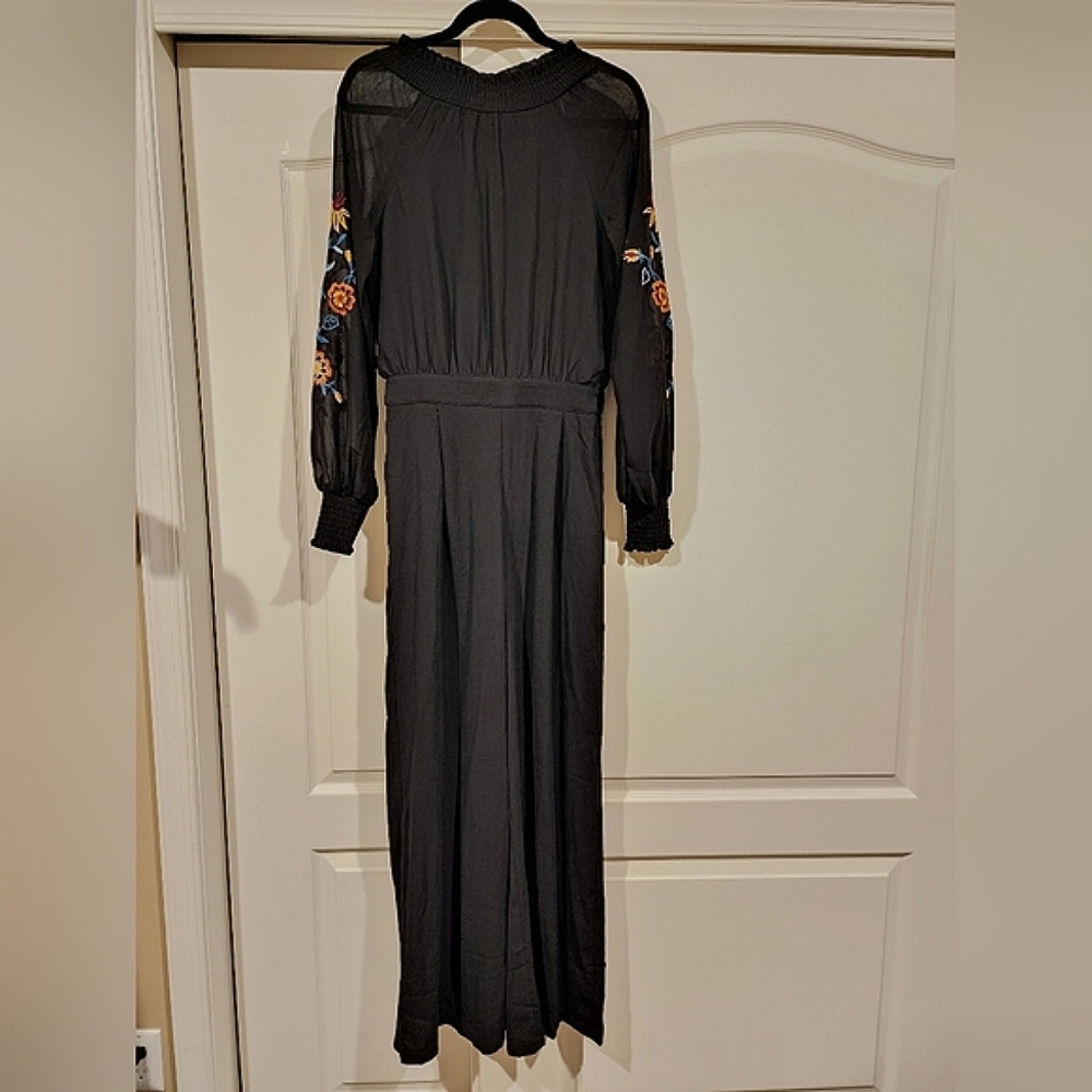 Small Black Jumpsuit with open back. Embroidery print on sleeves